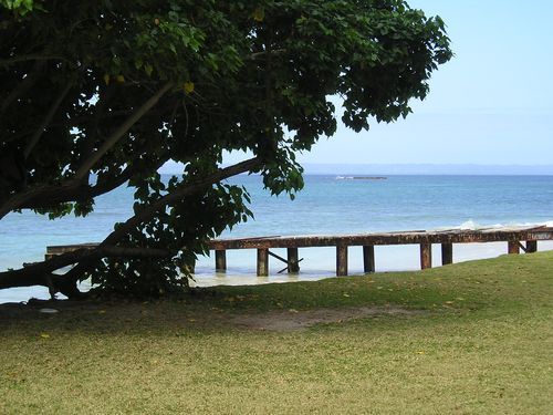 A view of the ocean with a dock in the foreground