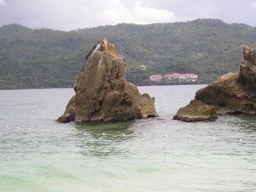 A large rock in the middle of a body of water