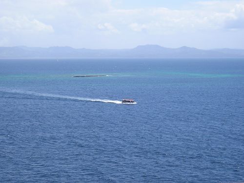 A boat is floating on top of a large body of water.