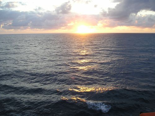 The sun is setting over a large body of water