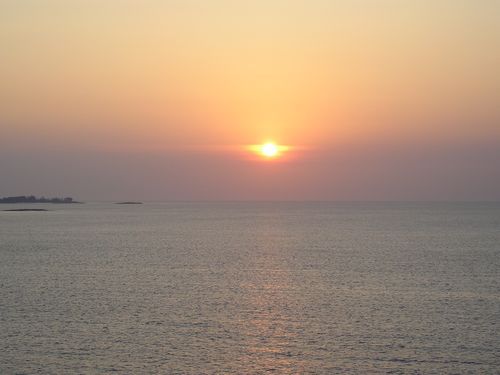 The sun is setting over the ocean