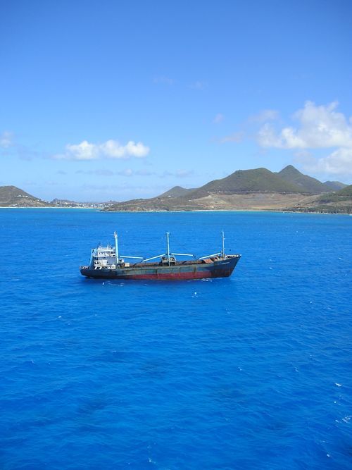 A large ship is floating on top of a large body of water