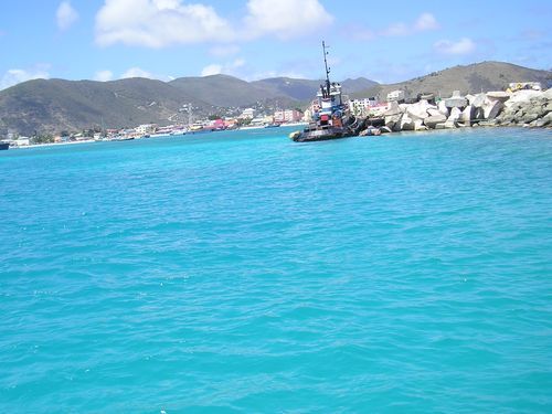 A boat is floating on top of a large body of water.