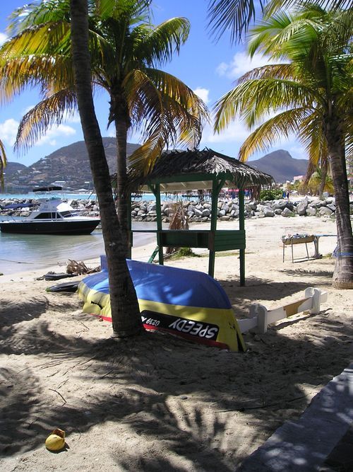 A boat on a beach with a speedy sticker on the side