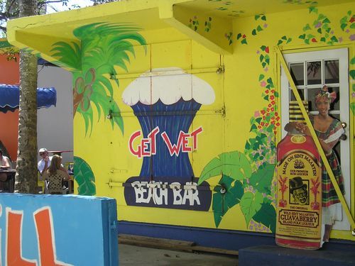 A yellow building with a sign that says get wet