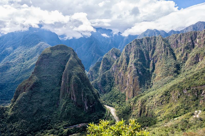 A view of a mountain range with a road going through it.