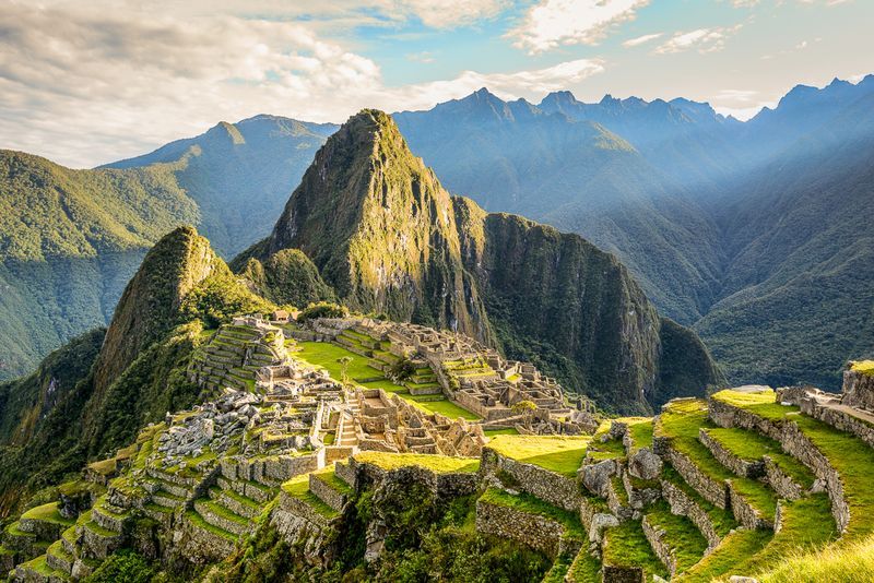 The ruins of the inca city of machu picchu are surrounded by mountains.