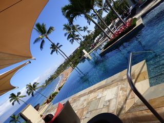A swimming pool with palm trees in the background