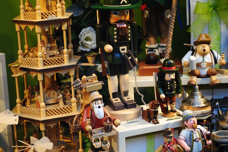 A display of wooden toys including a nutcracker and a pyramid