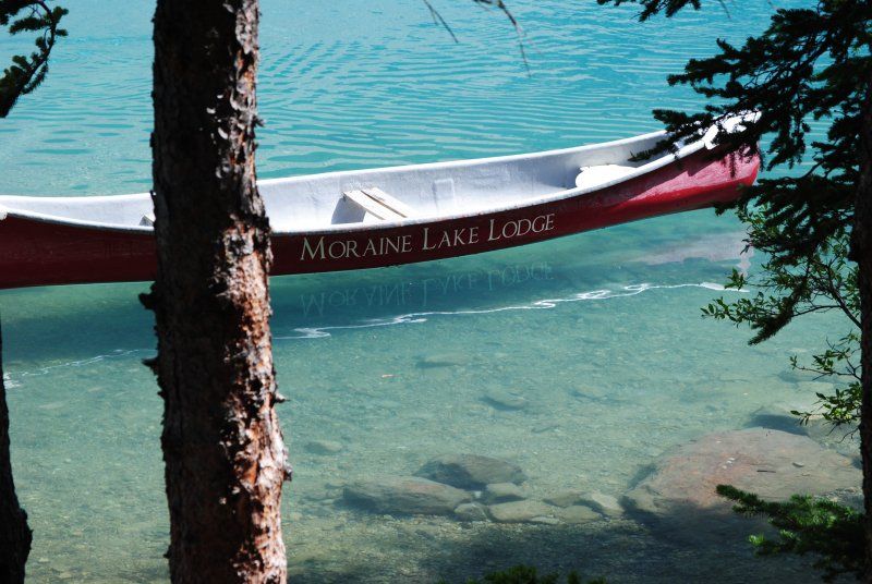 A red and white canoe that says moraine lake lodge