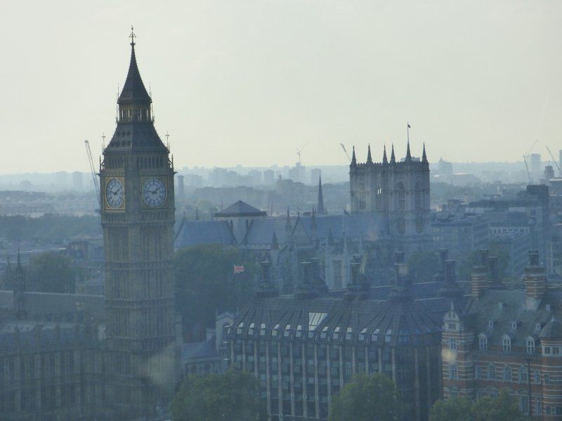 A large clock tower in the middle of a city