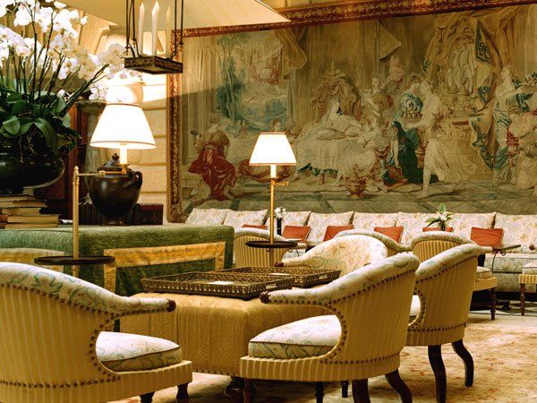 A living room with wicker chairs tables and lamps