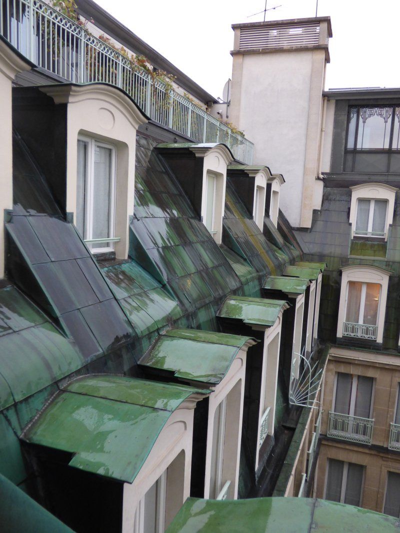 A building with a lot of windows and green roofs