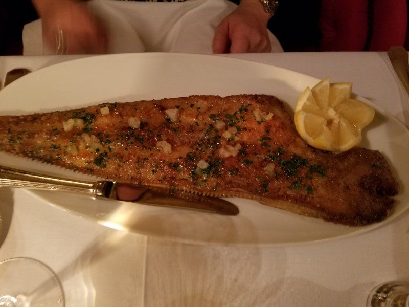 A plate of food with a slice of lemon on it