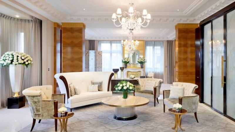 A living room filled with furniture and a chandelier.