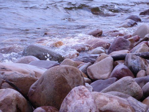 A rocky beach with waves crashing on the rocks