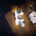 A wooden table topped with a tray of food and a clock.