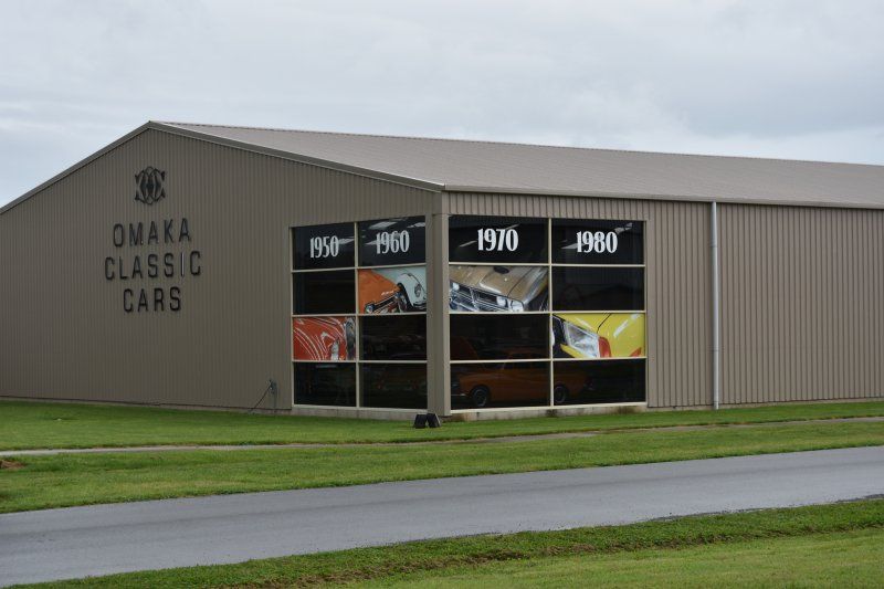 A large building with a lot of windows and a sign that says omaha class c cars.