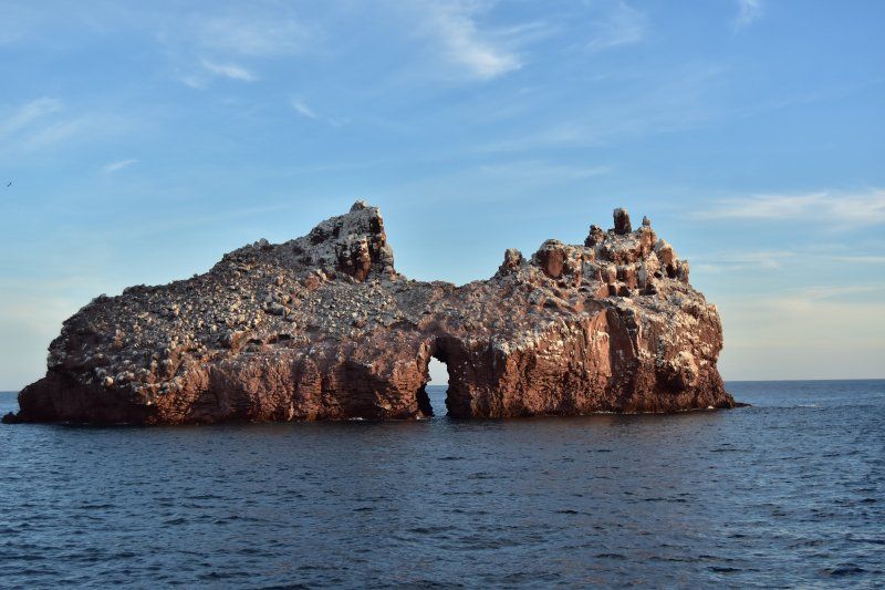 A large rock formation in the middle of the ocean