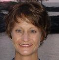 A woman with short brown hair is smiling for the camera.