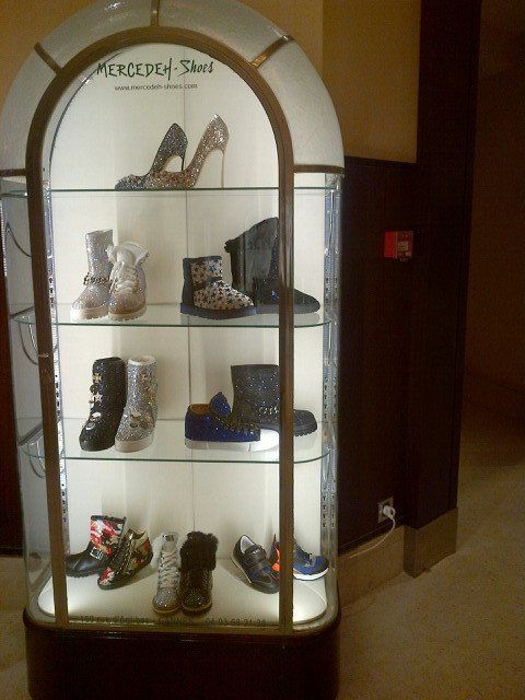 A shoe display case with a sign that says mercedes shoes