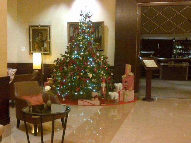 A hotel lobby with a christmas tree in the middle