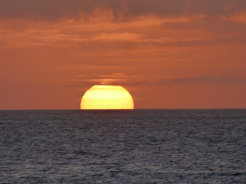 The sun is setting over the ocean