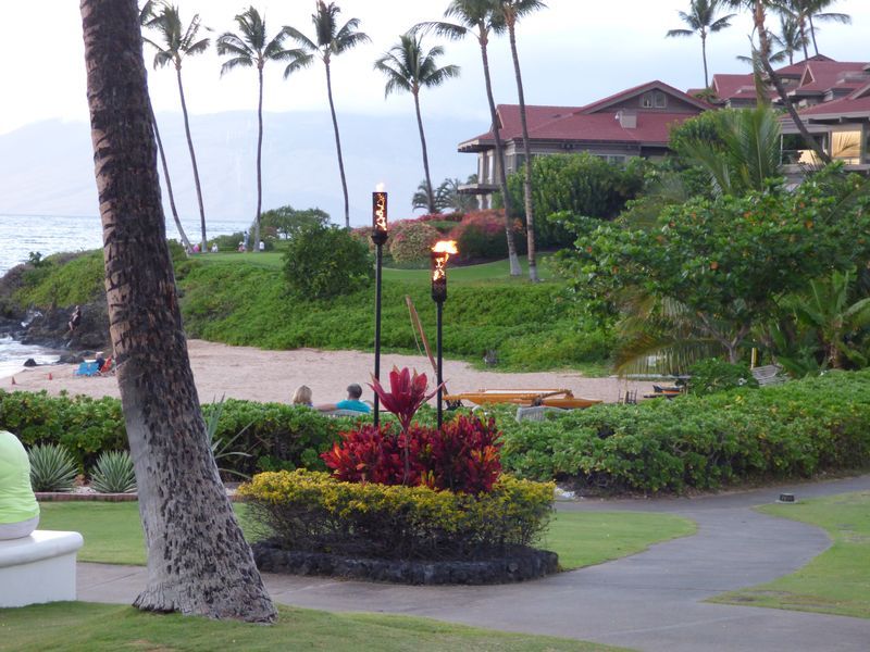 A view of a beach with a torch in the foreground