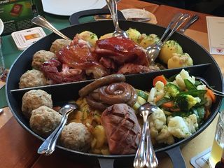 A pan filled with meat and vegetables on a table