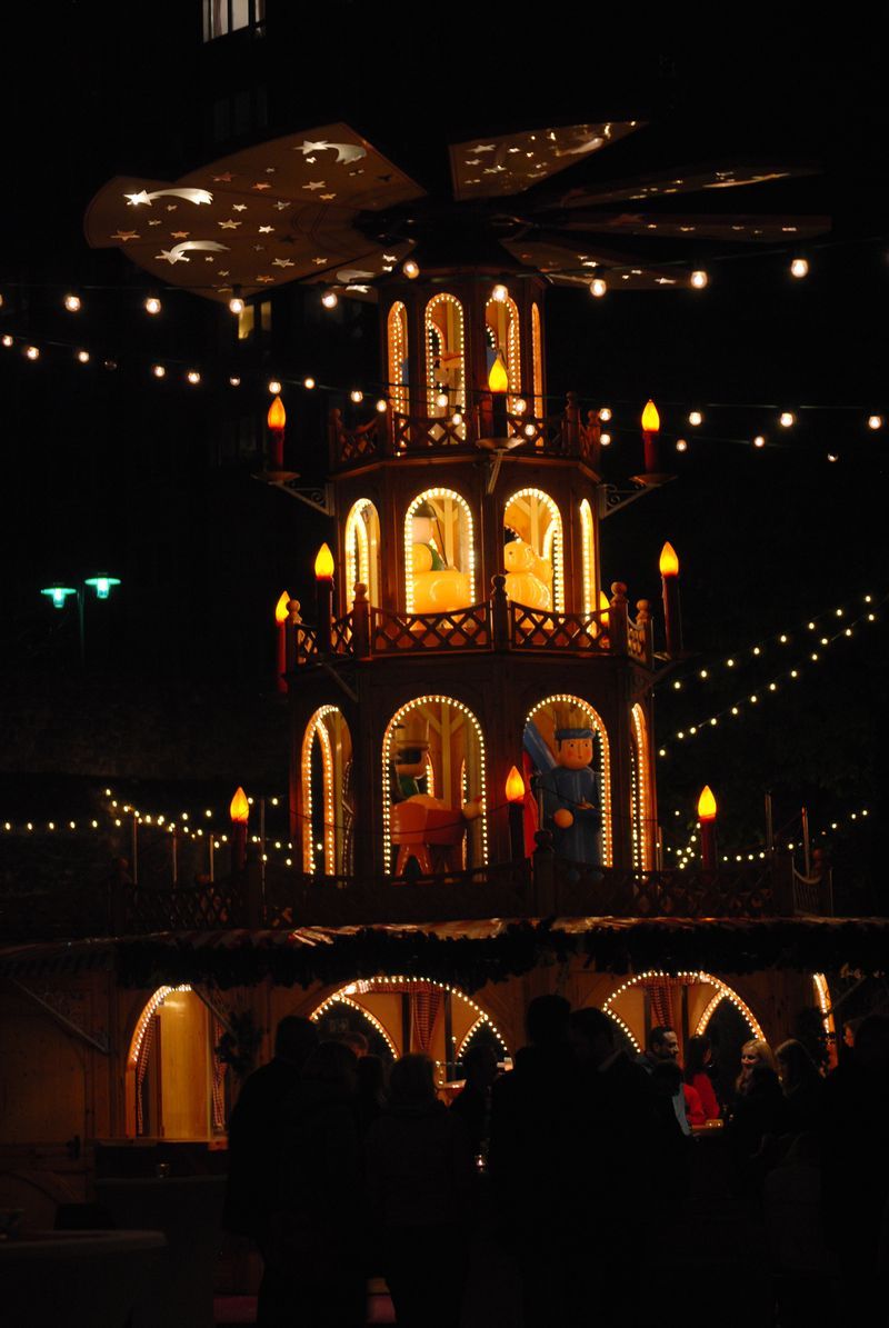 A large christmas pyramid is lit up at night