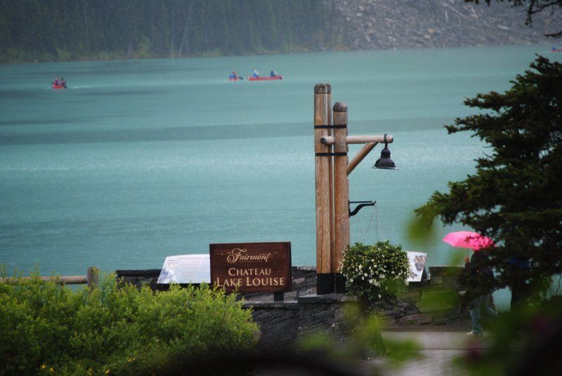 A sign that says family castle lake lodge in front of a lake