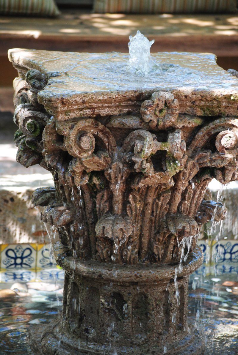 A close up of a fountain with water coming out of it.