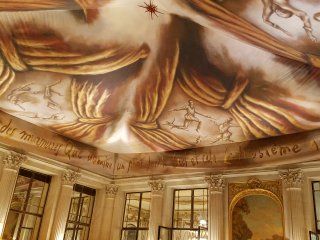 A large room with a painting on the ceiling