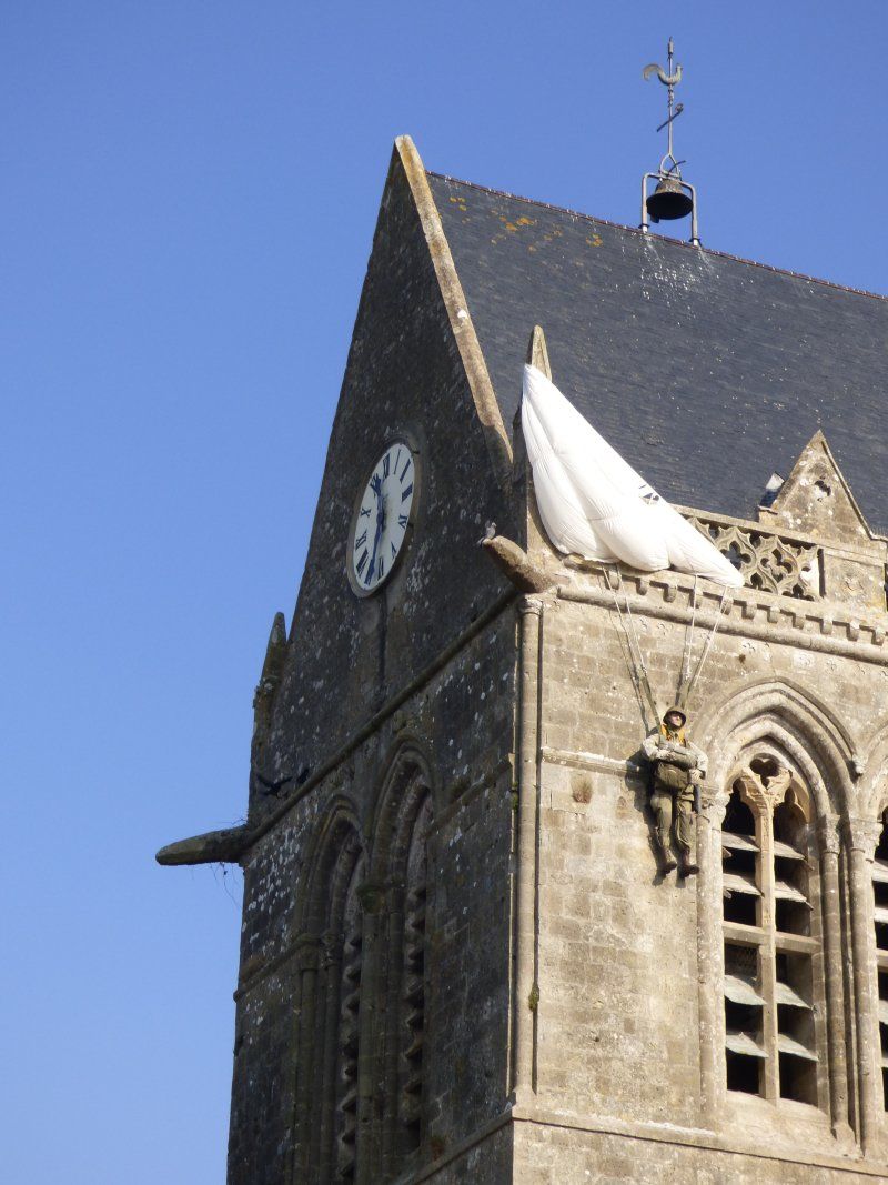 A clock tower with a flag on top of it