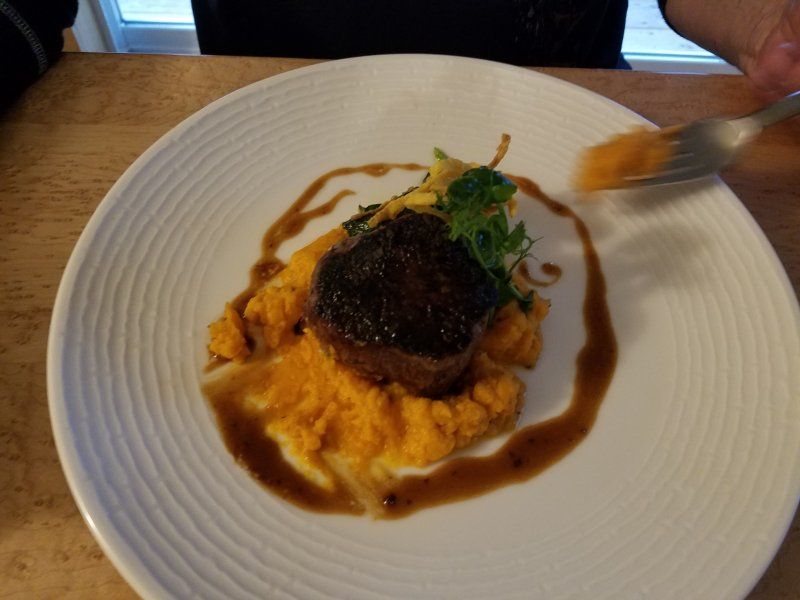 A plate of food with mashed potatoes and meat on it