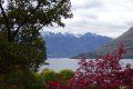 A lake with mountains in the background and trees in the foreground.