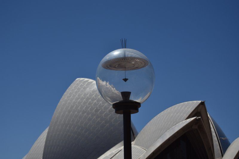 A street light in front of the opera house in sydney