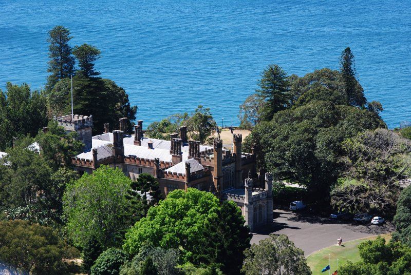 An aerial view of a castle surrounded by trees and a body of water