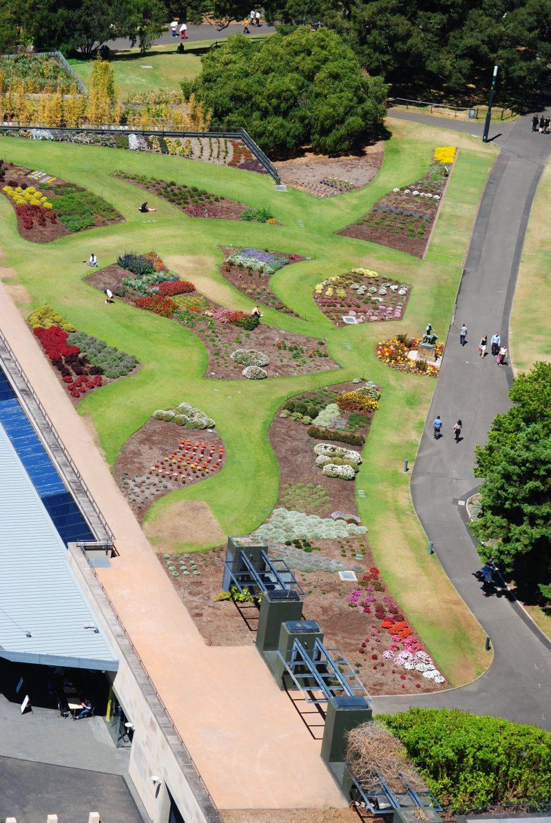 An aerial view of a park with lots of flowers and trees