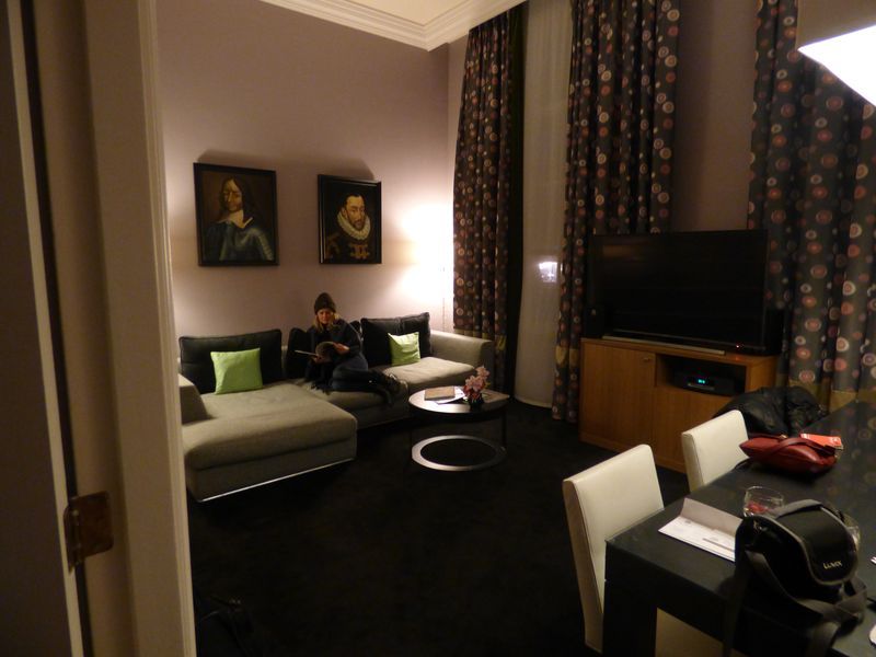 A man sits on a couch in a living room