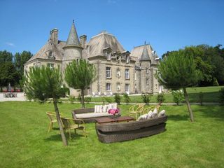 A large castle with a lot of furniture in front of it.