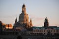 A blurry picture of a city skyline with a clock tower in the foreground.