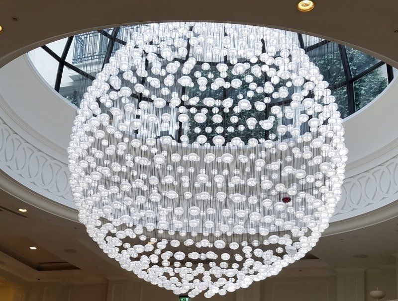 A large chandelier is hanging from the ceiling of a building