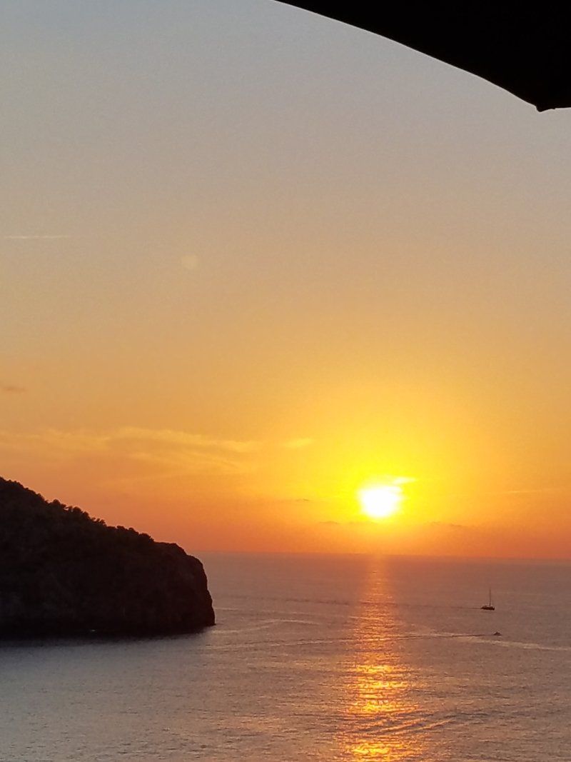 The sun is setting over a body of water