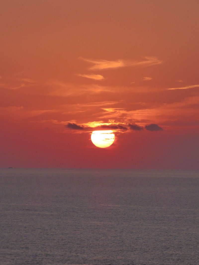 The sun is setting over the ocean