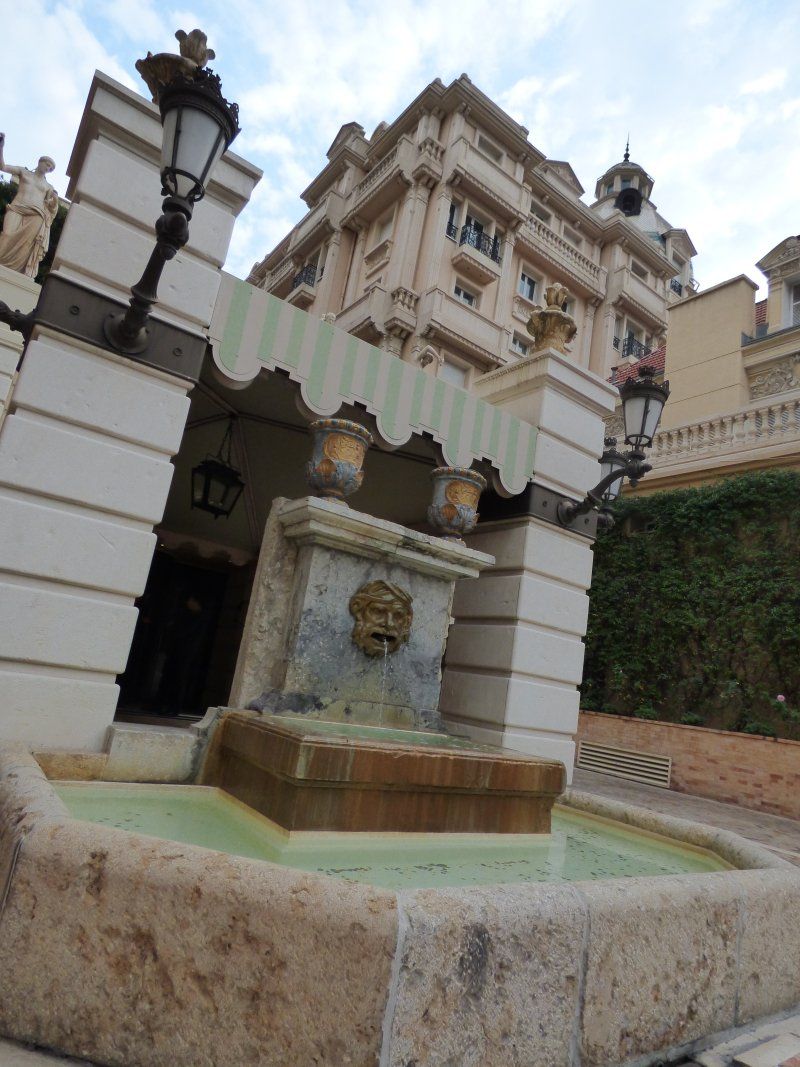 A large building with a fountain in front of it