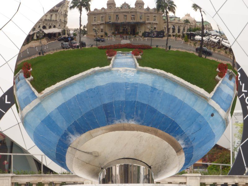 A reflection of a building in a mirror with the letter l on it