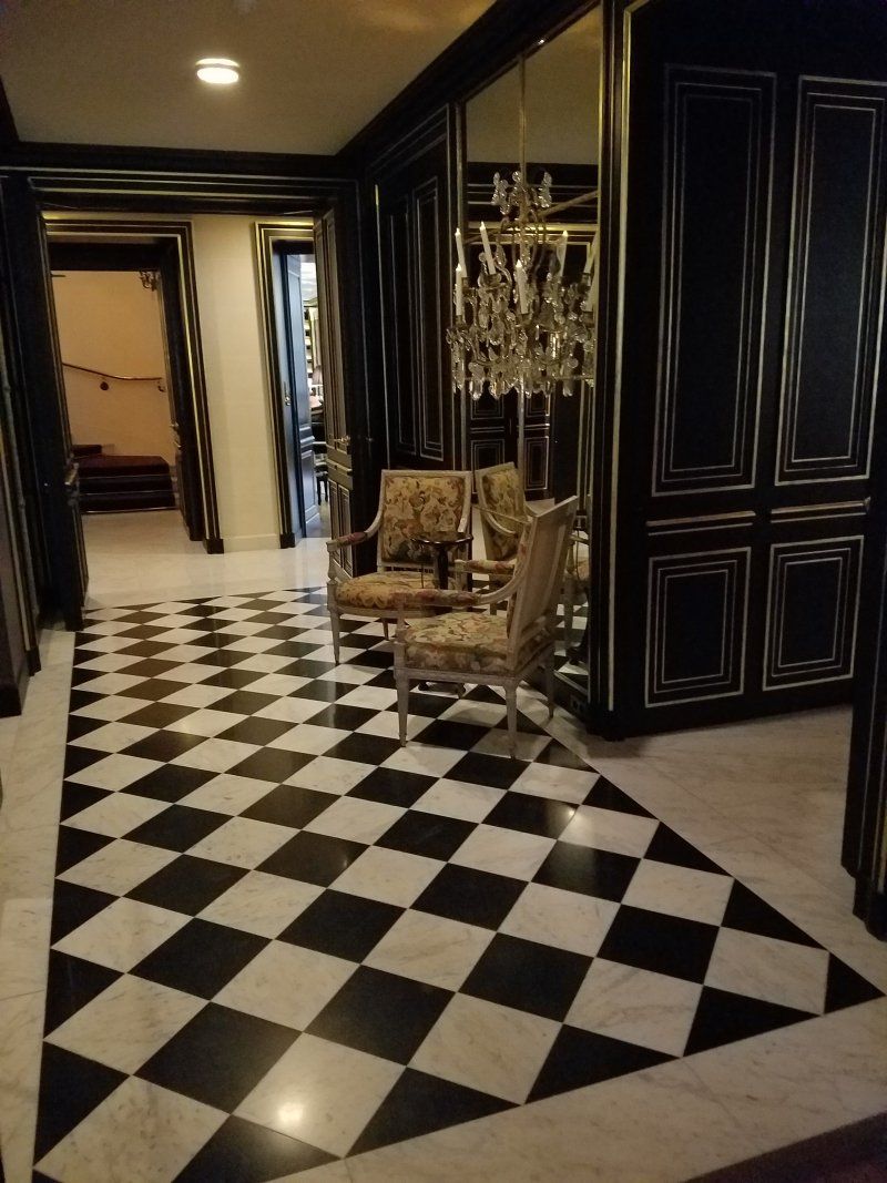 A black and white checkered floor in a hallway