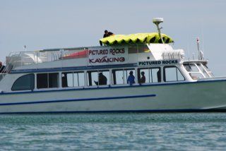 A pictured rocks boat is floating on the water