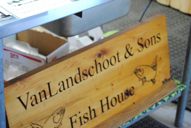 A wooden sign for van landschoot & sons fish house